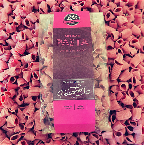 Paccheri pasta package with beetroot on a bed of pink pasta