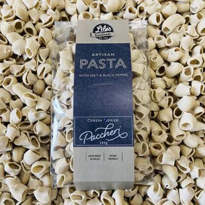 Paccheri pasta package with a background of uncooked pasta